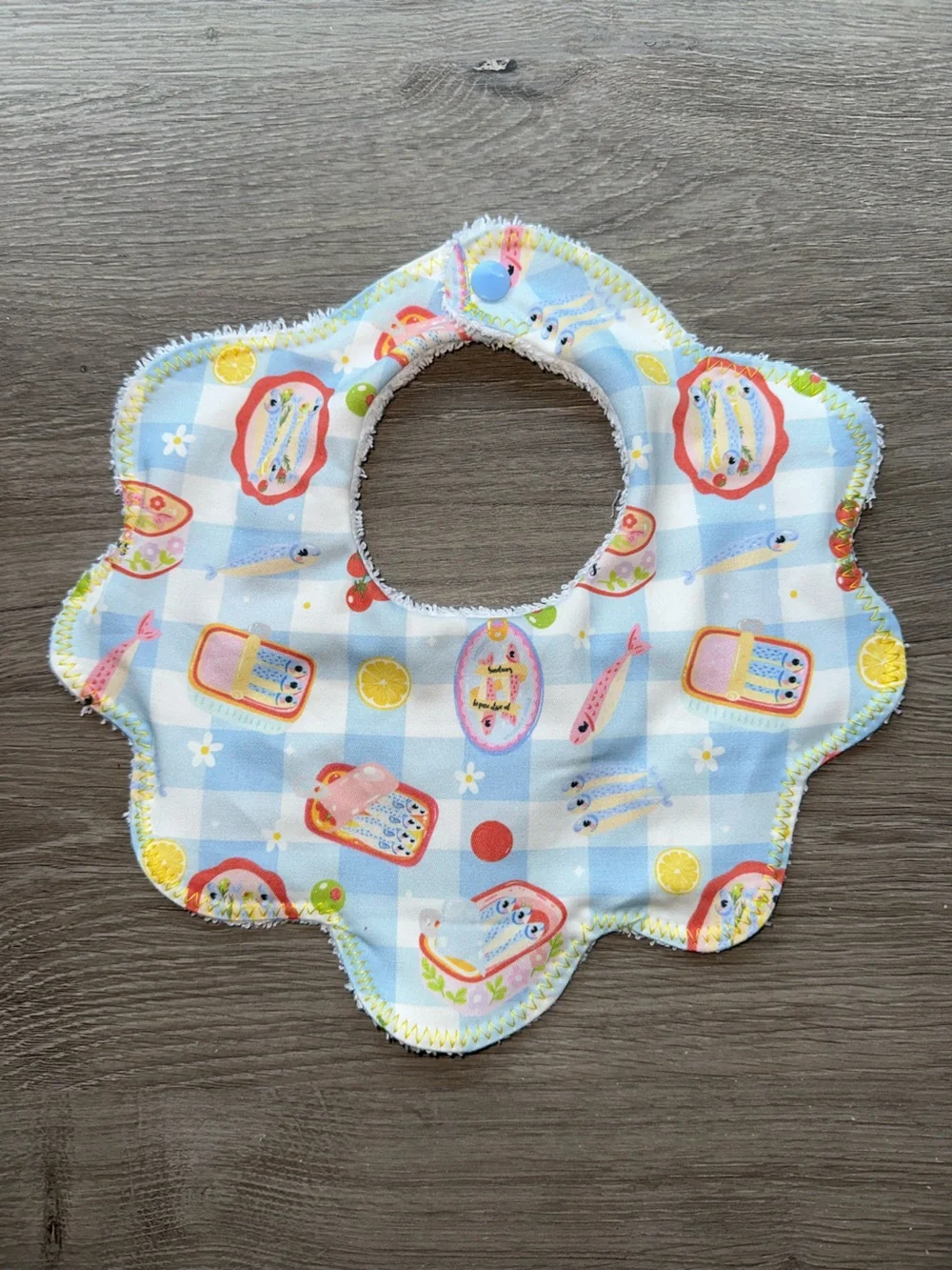 Kids Floral Edge Bib in Light Blue Check Pattern